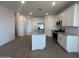 A spacious kitchen with a large island, stainless steel appliances, and tile flooring at 32723 N Newby Dr, San Tan Valley, AZ 85140