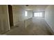 An expansive unfinished living room offers natural light and slider door, highlighting the construction at 32723 N Newby Dr, San Tan Valley, AZ 85140