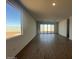 Large living room features a window and sliding glass doors to the backyard at 32723 N Newby Dr, San Tan Valley, AZ 85140