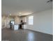 Open living space with kitchen, stainless steel appliances, and wood-look tile flooring at 32723 N Newby Dr, San Tan Valley, AZ 85140