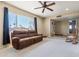 Cozy living room featuring carpeted floors, a comfortable sofa, and a large window at 3640 W Redfield Rd, Phoenix, AZ 85053