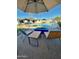 Cozy backyard with pool, firepit, and comfortable seating arrangement on a brick paved patio at 3807 E Altadena Ave, Phoenix, AZ 85028