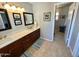 Bathroom with double sinks, wood cabinets, and tile floors and countertops at 3807 E Altadena Ave, Phoenix, AZ 85028