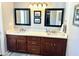 Bathroom with double sinks, wood cabinets, and tile floors and countertops at 3807 E Altadena Ave, Phoenix, AZ 85028