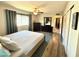 The bedroom features a ceiling fan, wood floors, and two dark wood dressers at 3807 E Altadena Ave, Phoenix, AZ 85028