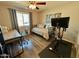Cozy bedroom with a comfortable daybed, desk, and workout bike, perfect for a multi-functional space at 3807 E Altadena Ave, Phoenix, AZ 85028