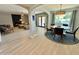Open concept dining area featuring modern table, chairs, and connecting to the living area with a fireplace at 3807 E Altadena Ave, Phoenix, AZ 85028