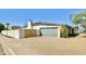 View of the house showing a private yard, block fence, mature landscaping, and a garage at 3807 E Altadena Ave, Phoenix, AZ 85028