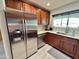 Updated kitchen features stainless steel appliances, stone countertops and tile backsplash at 3807 E Altadena Ave, Phoenix, AZ 85028
