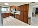 Spacious kitchen featuring wooden cabinets, stainless steel appliances, and a view to the main living area at 3807 E Altadena Ave, Phoenix, AZ 85028