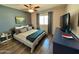 Comfortable main bedroom with ensuite bath, a brick wall, and ample natural light at 3807 E Altadena Ave, Phoenix, AZ 85028