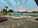 Dusk view of a backyard featuring a private pool and spa, complemented by landscape lighting at 3807 E Altadena Ave, Phoenix, AZ 85028
