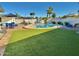 This backyard has a private pool, vibrant turf, and ample seating, perfect for outdoor enjoyment at 3807 E Altadena Ave, Phoenix, AZ 85028