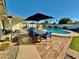 Lush backyard featuring pool, spa, outdoor dining area, and seating area, perfect for relaxation and entertainment at 3807 E Altadena Ave, Phoenix, AZ 85028