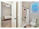 Bathroom showcasing shower with glass doors, toilet, and window creating a bright space with neutral colors at 40202 N Oakhurst Ct, Anthem, AZ 85086