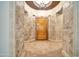 Grand foyer features stone-look walls, decorative tile floor inlay, and wood front door at 40202 N Oakhurst Ct, Anthem, AZ 85086