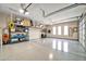 Spacious garage with high ceilings, epoxy flooring, and ample shelving for storage at 40202 N Oakhurst Ct, Anthem, AZ 85086