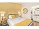 Bedroom boasts an en suite bathroom, a bright yellow accent wall, and stylish decor at 406 E Washington Ave # C, Gilbert, AZ 85234