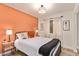 Bedroom with orange accent wall, bedside tables, and modern decor at 406 E Washington Ave # C, Gilbert, AZ 85234