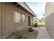 Close-up of a stucco home exterior, showcasing a window, entry, and landscaped walkway at 406 E Washington Ave # C, Gilbert, AZ 85234