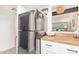 Modern kitchen with stainless steel refrigerator and a breakfast bar at 406 E Washington Ave # C, Gilbert, AZ 85234