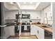 Well-equipped kitchen with stainless steel appliances, white cabinets, and ample counter space at 406 E Washington Ave # C, Gilbert, AZ 85234
