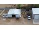 Aerial view of outbuildings, barns and sheds plus a large grassy yard, ideal for rural living and hobby farming at 4311 W Siesta Way, Laveen, AZ 85339