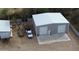 Aerial view of a large barn with two bay doors and a truck with trailers parked outside in a large dirt lot at 4311 W Siesta Way, Laveen, AZ 85339