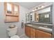 Bathroom featuring double sinks, decorative mirror, and wood cabinets at 4311 W Siesta Way, Laveen, AZ 85339