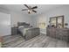 Bedroom with wood-look floors, full bedroom set, natural light and ceiling fan at 4311 W Siesta Way, Laveen, AZ 85339