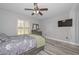 Bedroom with gray walls, wood-look floors, and natural light from window with white shutters at 4311 W Siesta Way, Laveen, AZ 85339