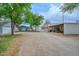 Wide view of outbuildings and a long gravel driveway at 4311 W Siesta Way, Laveen, AZ 85339