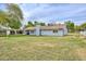 Exterior view of the home featuring a white fence and lush green grass yard at 4311 W Siesta Way, Laveen, AZ 85339