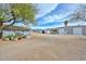 Wide view of desert property with home, outbuildings, and planter boxes at 4311 W Siesta Way, Laveen, AZ 85339