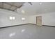 Spacious garage featuring white walls, epoxy flooring, recessed lighting, and two windows at 4311 W Siesta Way, Laveen, AZ 85339