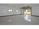 Bright garage with epoxy floors, white walls, recessed lighting, and a partially open garage door at 4311 W Siesta Way, Laveen, AZ 85339