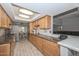 Bright kitchen featuring wood cabinetry, stainless steel appliances and marble countertops at 4311 W Siesta Way, Laveen, AZ 85339