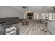 Spacious living room features modern gray flooring, ceiling fan, and a stylish stone fireplace at 4311 W Siesta Way, Laveen, AZ 85339