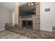 Close up of a stone fireplace with decoratvie mantle in a living room at 4311 W Siesta Way, Laveen, AZ 85339