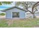 Charming outbuilding with open garage door and a white picket fence at 4311 W Siesta Way, Laveen, AZ 85339