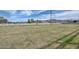 Large grassy yard enclosed by a white fence, offers plenty of space for outdoor activities with mountain views at 4311 W Siesta Way, Laveen, AZ 85339
