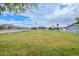 Expansive green lawn with a white fence, surrounded by lush greenery and mountain views at 4311 W Siesta Way, Laveen, AZ 85339