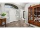 Bright foyer featuring tile flooring, a decorative cabinet, and ample natural light at 45290 W Juniper Ave, Maricopa, AZ 85139