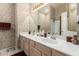 Traditional bathroom featuring double sinks, decorative wallpaper and plenty of counter space at 4531 W Flint St, Chandler, AZ 85226