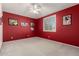 Empty bedroom featuring neutral carpet, red walls, and a window with white shutters at 4531 W Flint St, Chandler, AZ 85226
