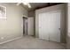 Bedroom with neutral carpet and walls, and white bi-fold closet doors at 4531 W Flint St, Chandler, AZ 85226