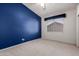 Bright bedroom featuring a large window that provides natural light and a deep blue accent wall at 4531 W Flint St, Chandler, AZ 85226