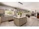 Large kitchen island, tile backsplash and floors, with an open view into the living room at 4531 W Flint St, Chandler, AZ 85226