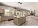 Open kitchen featuring a tile island, stainless appliances, and ample counter space; ideal for cooking and entertaining at 4531 W Flint St, Chandler, AZ 85226