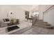 Bright living room featuring a sofa, dining area, staircase, and modern decor at 4531 W Flint St, Chandler, AZ 85226